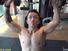 A handsome Asian man getting fit in the gym before a nipple play session.
