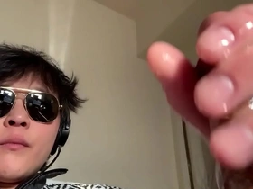 Asian man pleasuring himself and taking a selfie.