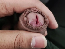 An Asian boy playing with his genitals.