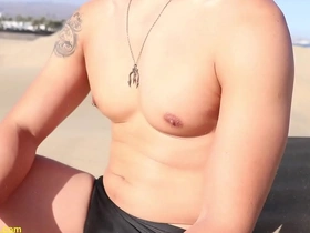 Muscular Asian man enjoys nipple stimulation on sandy hills